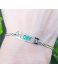 A bracelet with a Colombian emerald sourced from the Muzo mines very good quality, made in 14k yellow gold on a wrist.
