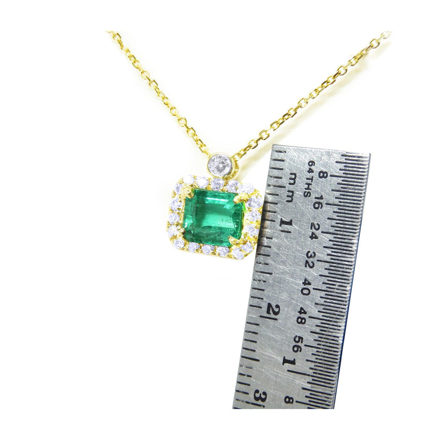 1.31 ct emerald-cut Muzo Colombian emerald necklace with diamonds in 14K yellow gold.