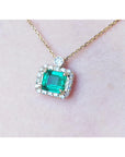 1.31 ct emerald-cut Muzo Colombian emerald necklace with diamonds in 14K yellow gold.