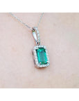 1.70 ct. Muzo Colombian emerald pendant with diamond halo on an 18K white gold chain.