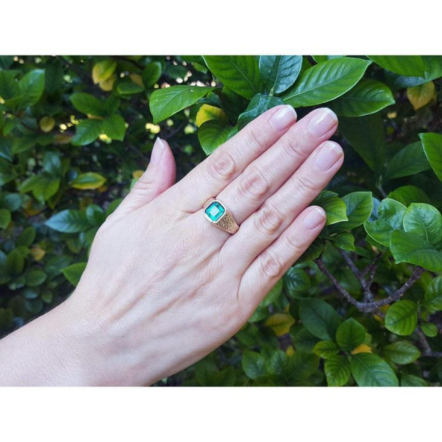 Men's 14K yellow gold ring with a rectangular emerald-cut bluish-green Colombian emerald, bezel set.