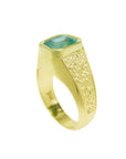 A men's yellow gold emerald solitaire ring displaying the top bezel setting and side band profile.