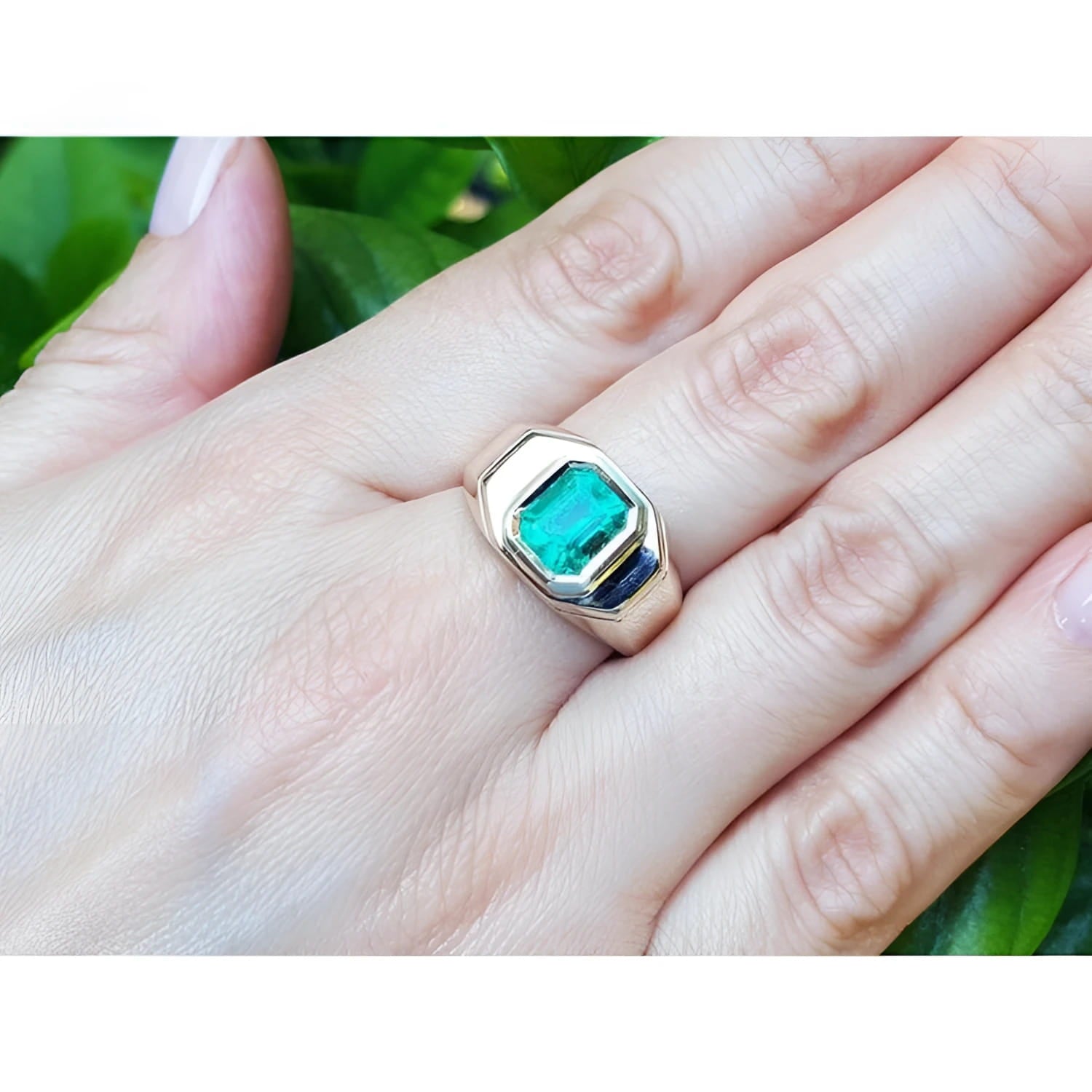 Men's 14K yellow gold ring with a rectangular 2.37 ct Muzo Colombian emerald and blue accents.