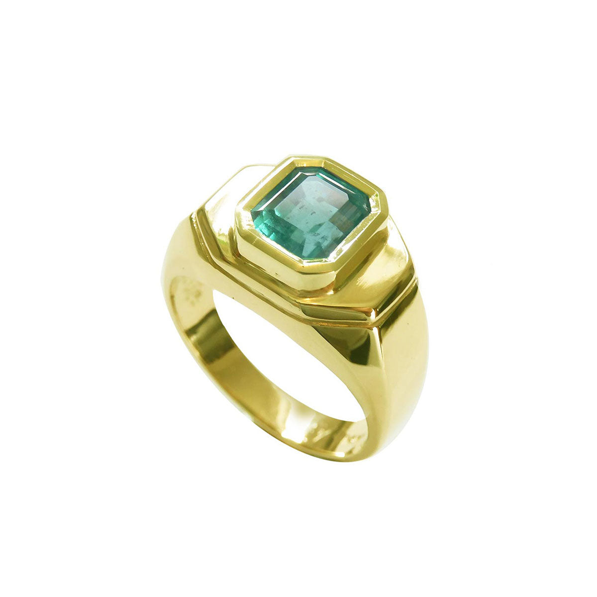 The tilted position of this yellow gold mens emerald ring displays the top bezel setting and a partial sides perspective.