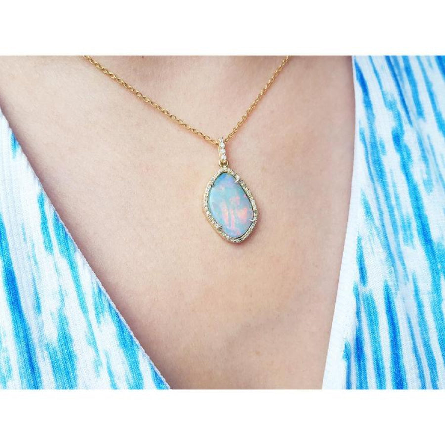 Australian opal pendant with fiery red-orange play-of-color, halo diamonds, and 18K yellow gold chain.