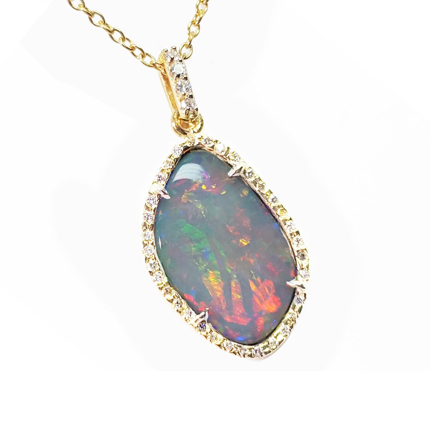 A natural solid Australian opal pendant with a halo diamond on a gold chain, topside view position.