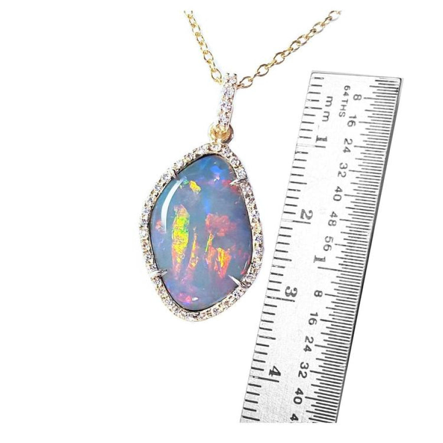 4.30 ct natural Australian opal pendant with fiery red-orange play-of-color, halo diamonds, and 18K yellow gold chain.