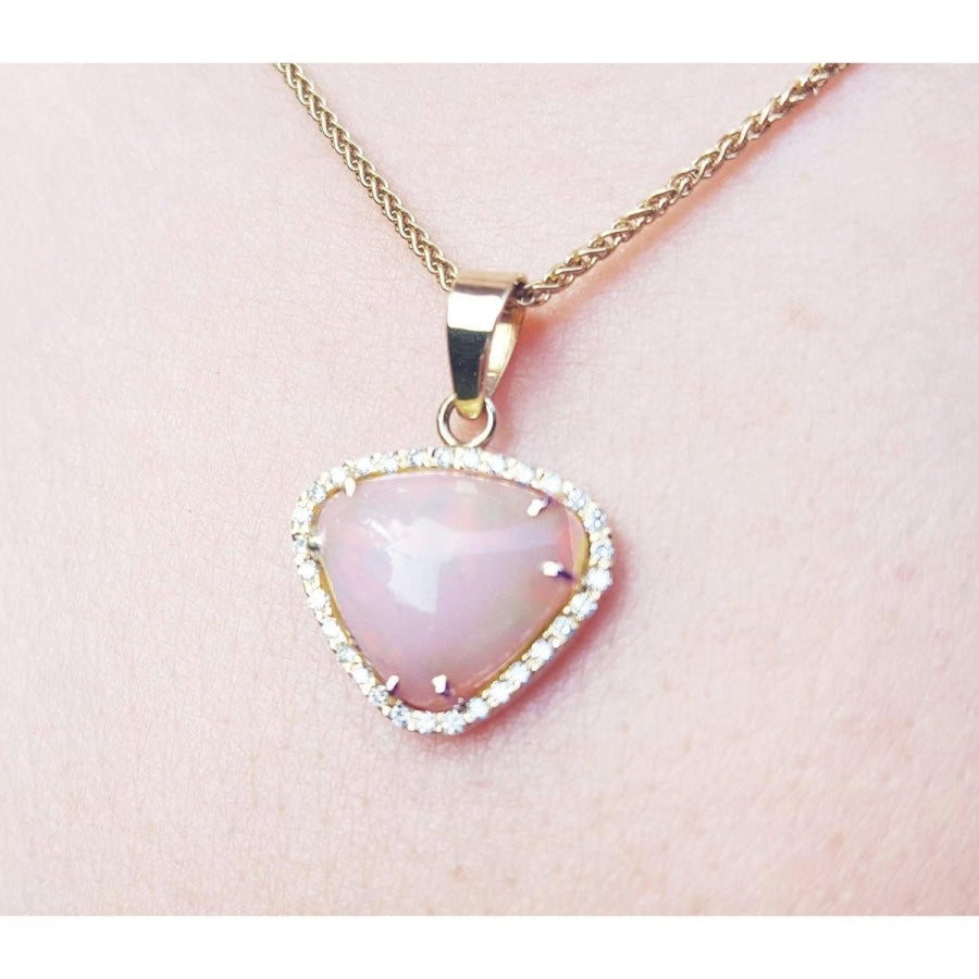 Natural Australian white opal pendant with red fire, diamond halo, and 14K yellow gold chain.