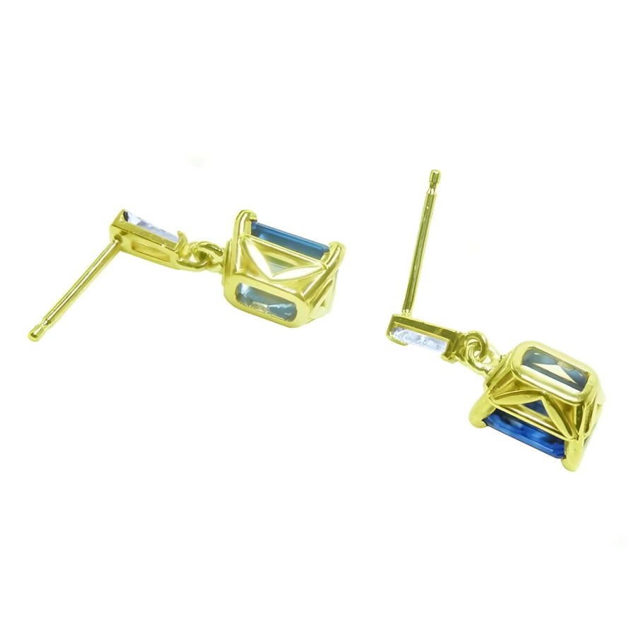 14K yellow gold blue sapphire emerald cut dangle earrings with tapered baguette diamonds.