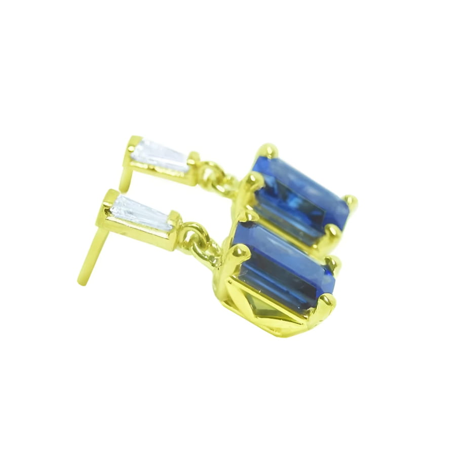 14K yellow gold blue sapphire emerald cut dangle earrings with tapered baguette diamonds.