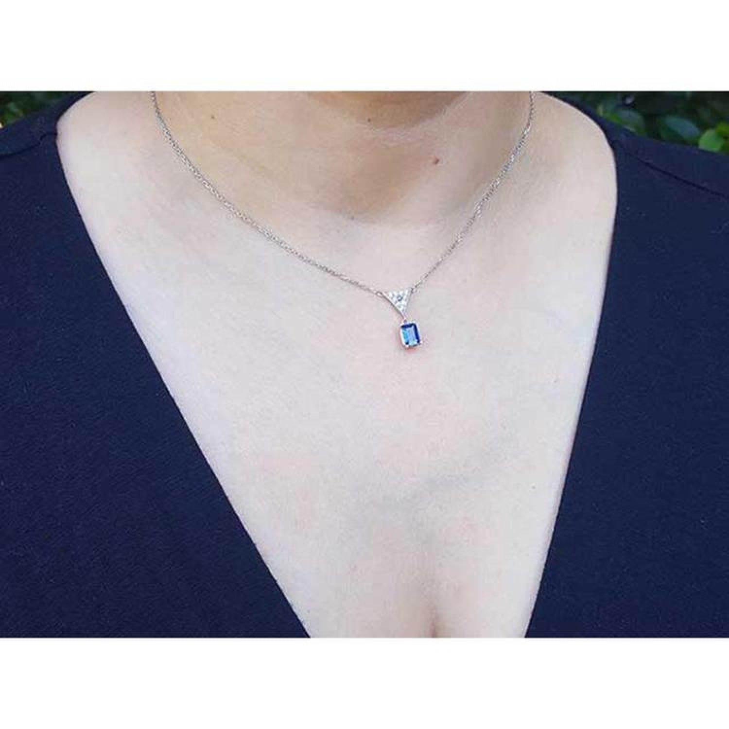 1.05 carat natural blue sapphire necklace in 14K white gold, with a trillion diamond centerpiece.