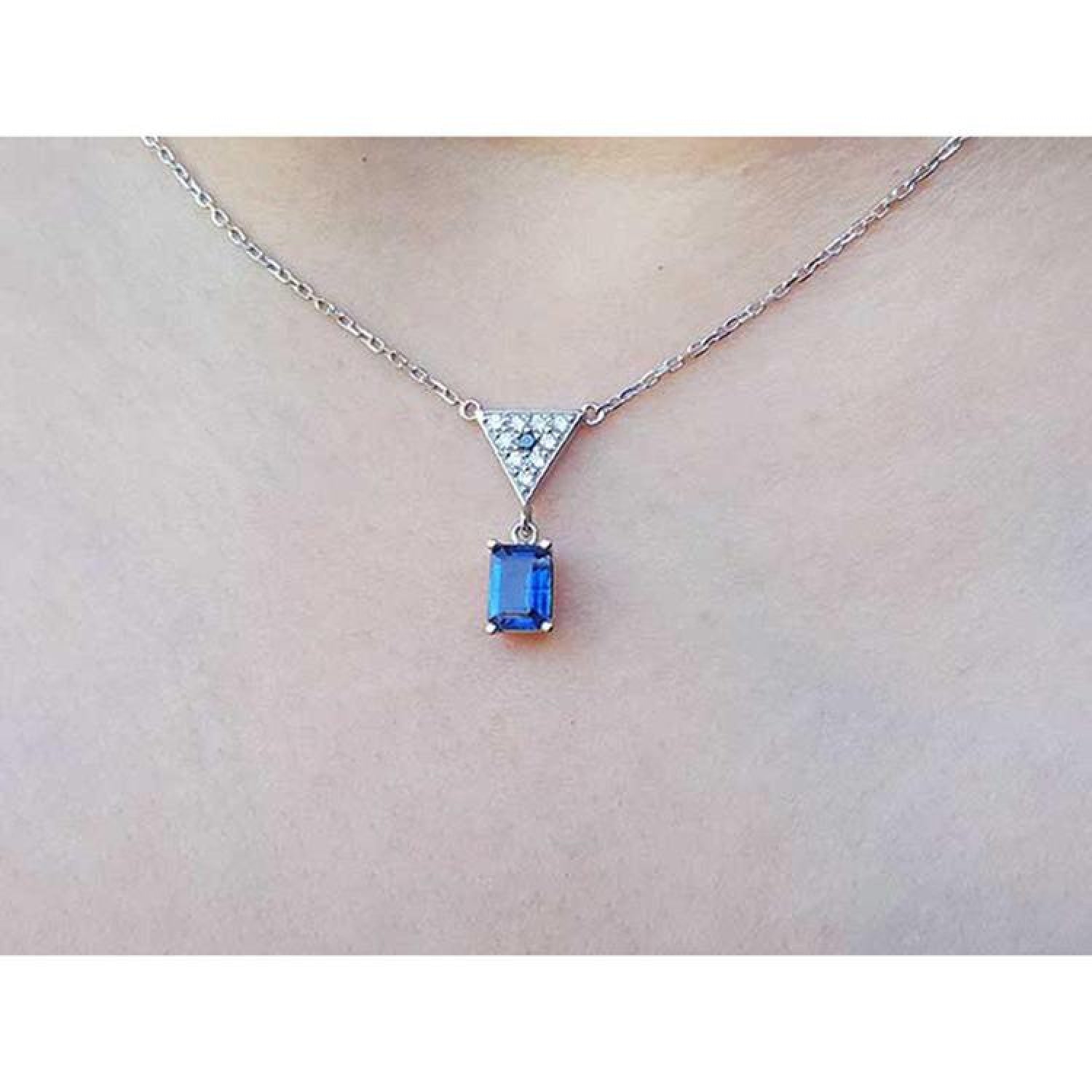 1.05 carat natural blue sapphire necklace in 14K white gold with a trillion diamond centerpiece.