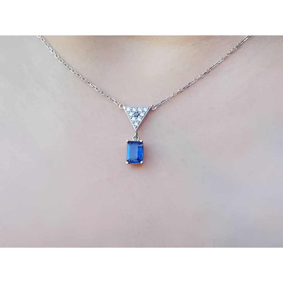 1.05 carat natural blue sapphire necklace in 14K white gold with a trillion diamond centerpiece.