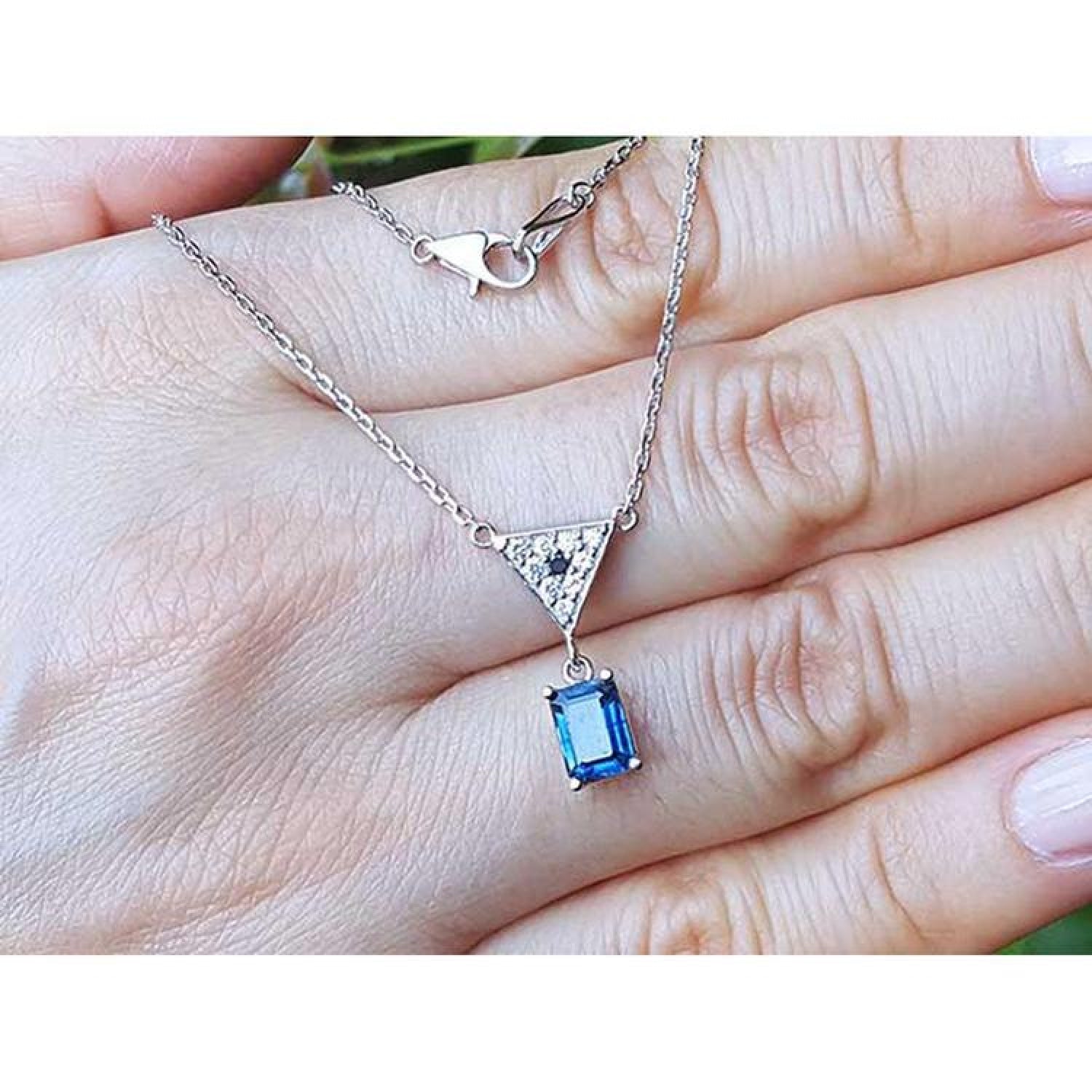 1.05 carat natural blue sapphire necklace in 14K white gold with a trillion diamond centerpiece.
