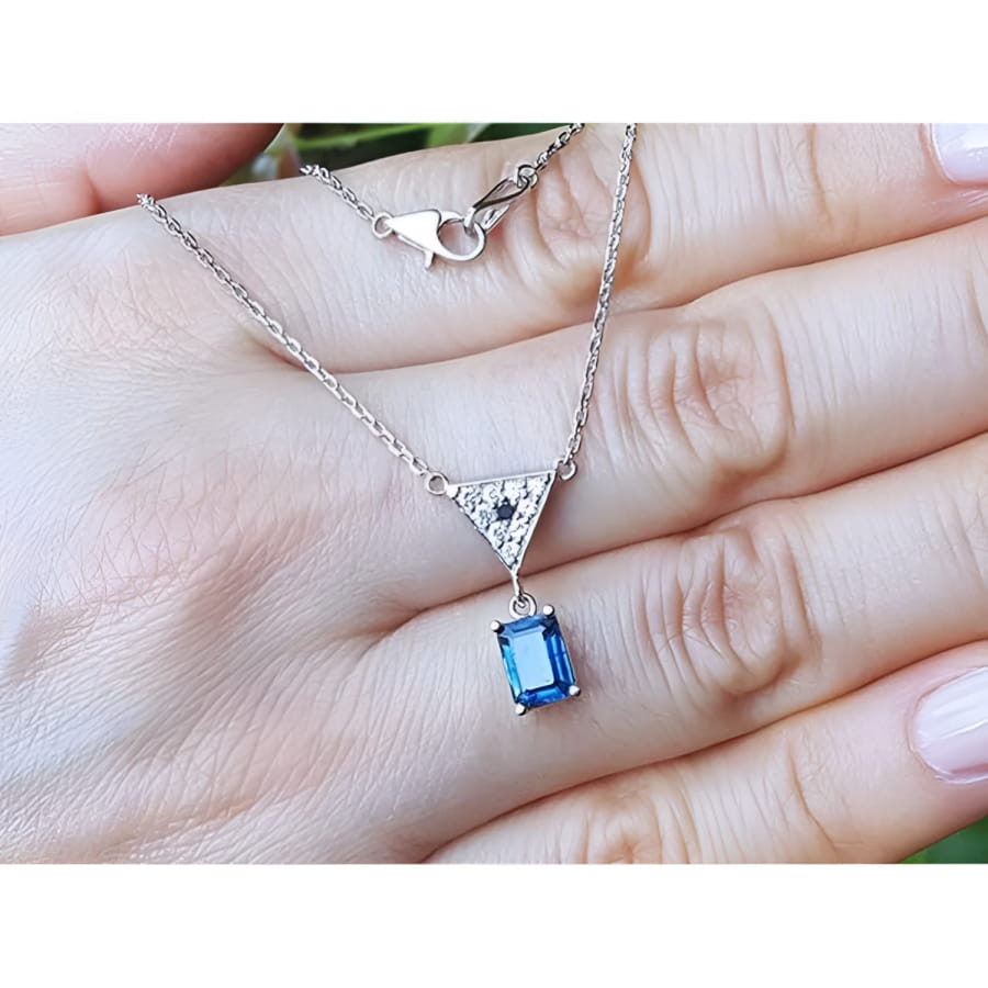 1.05 carat natural blue sapphire necklace in 14K white gold with a trillion diamond centerpiece.