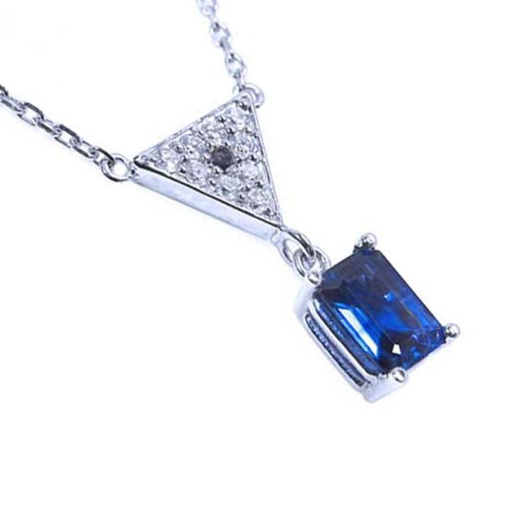 Right side profile view of a natural blue sapphire necklace with diamonds 14k white gold dangling pendant
