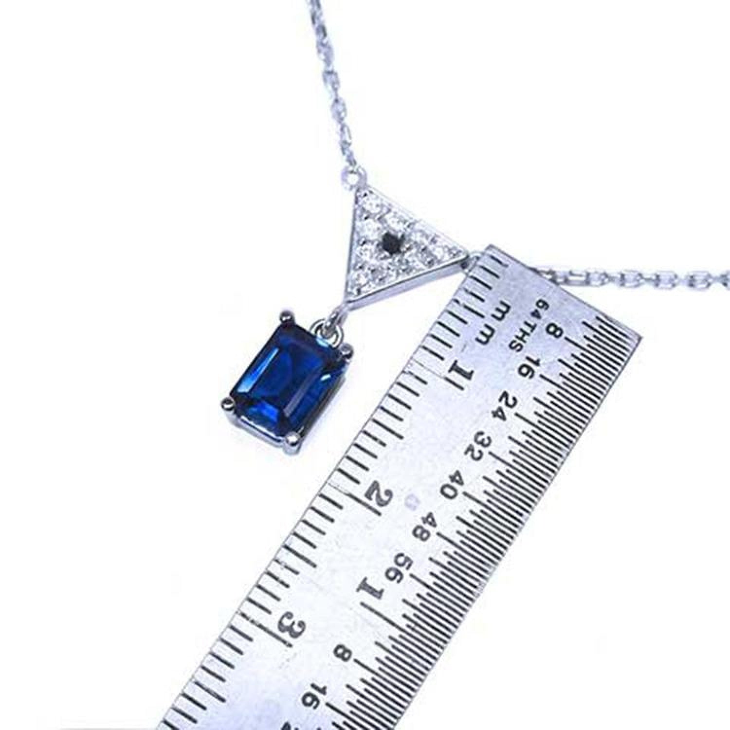 1.05 carat natural blue sapphire necklace in 14K white gold with a trillion diamond pendant.