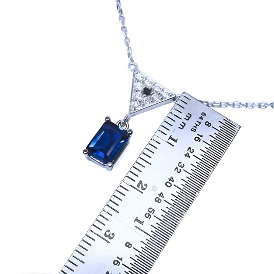1.05 carat natural blue sapphire necklace in 14K white gold with a trillion diamond pendant.