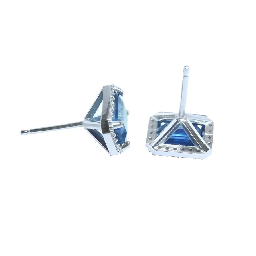 Emerald cut natural blue sapphire stud earrings with diamond halo in 14K white gold.
