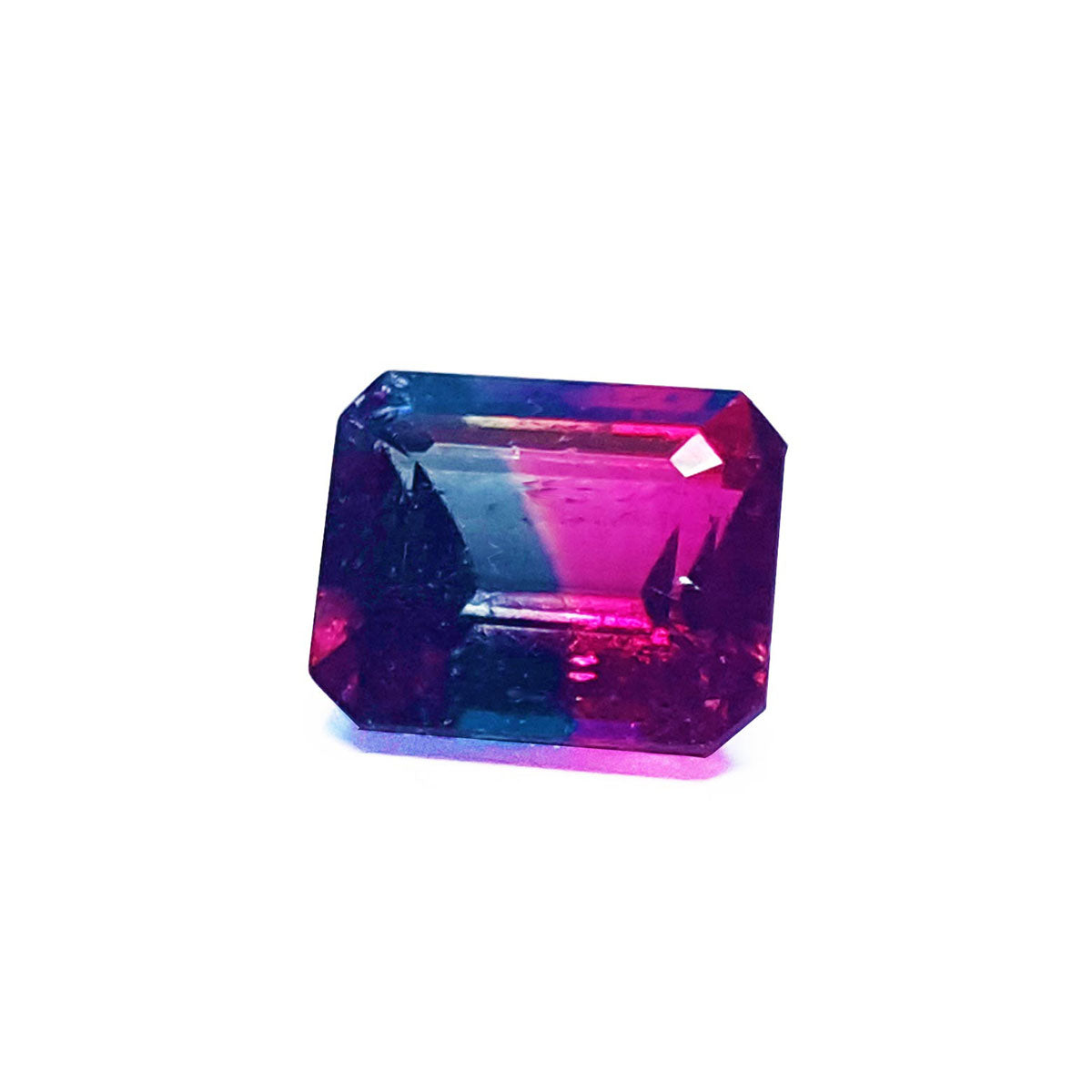 A faceted rectangular emerald cut watermelon tourmaline from Brazil displaying its left side profile top facets.