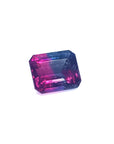 Faceted natural watermelon tourmaline with pink and blue colors on a white background.