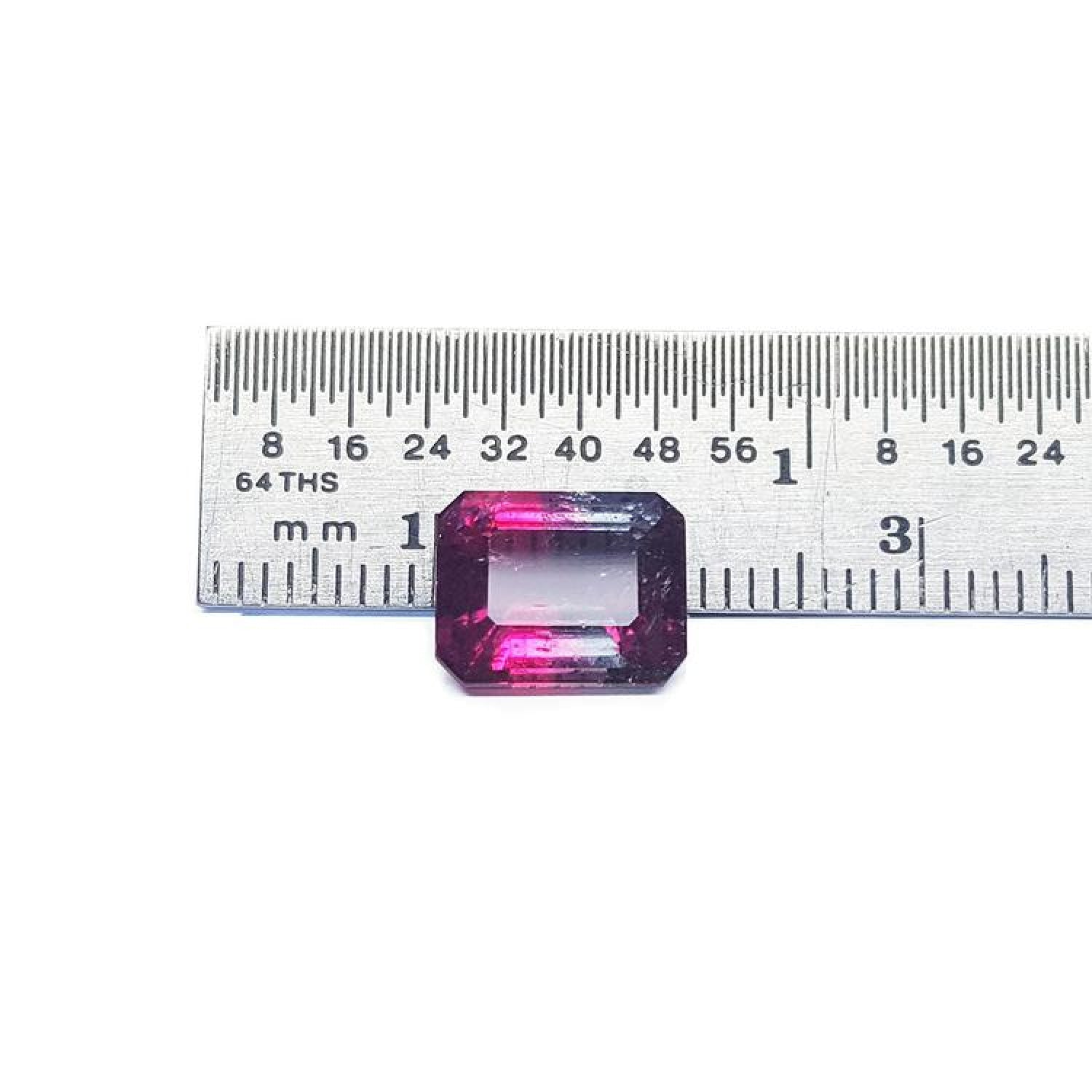Natural 3.55 ct. watermelon tourmaline, vibrant red and greenish-blue, emerald cut, next to a ruler.