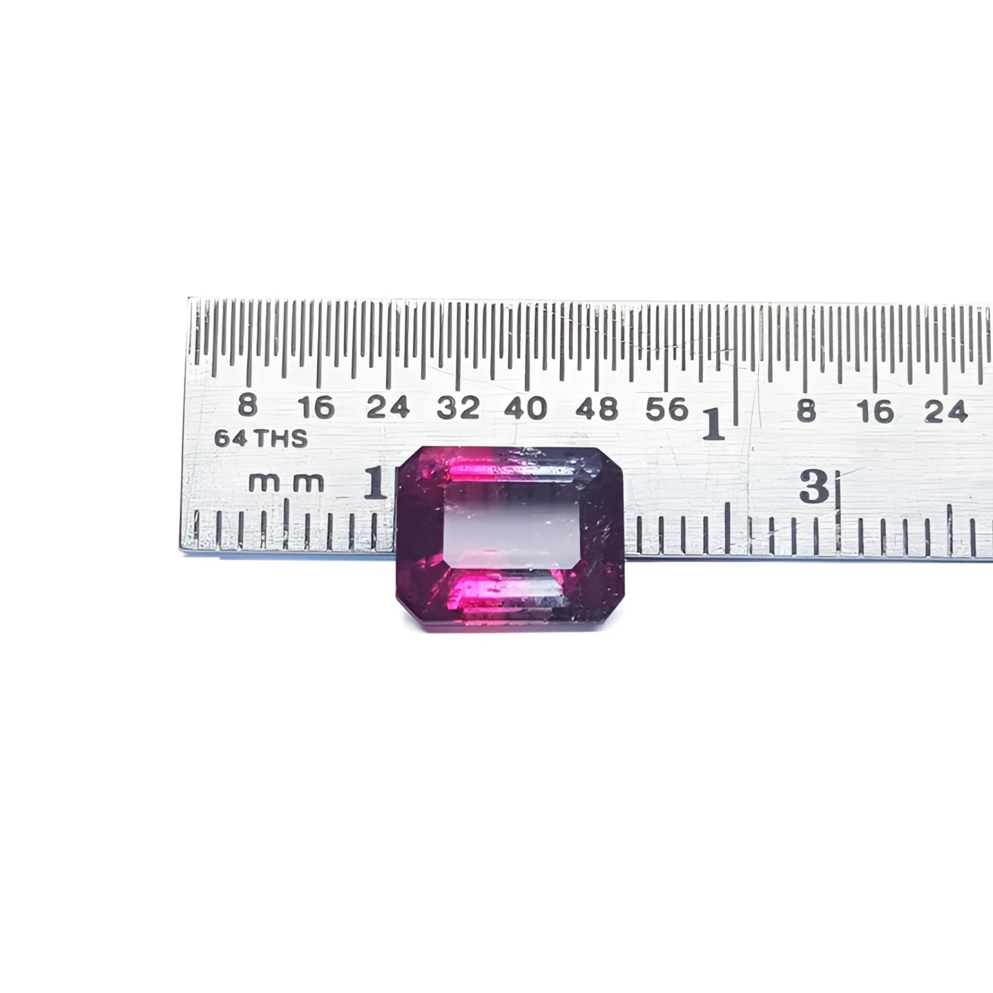 Natural 3.55 ct. watermelon tourmaline, vibrant red and greenish-blue, emerald cut, next to a ruler.