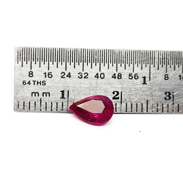 1.24 carat natural Burmese ruby, pear cut, brilliant medium red, shown next to a ruler.