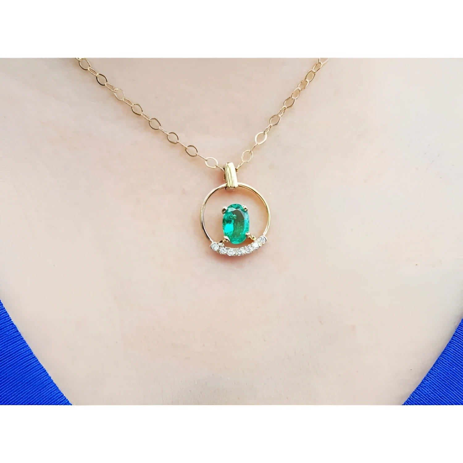 14k yellow gold necklace with oval natural Colombian emerald and diamond accents.