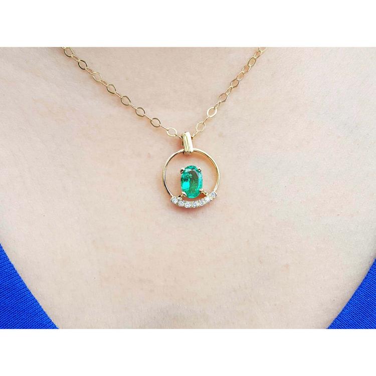 14k yellow gold necklace with oval natural Colombian emerald and diamond accents.