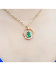 14k yellow gold necklace with oval natural Colombian emerald and diamond accents.