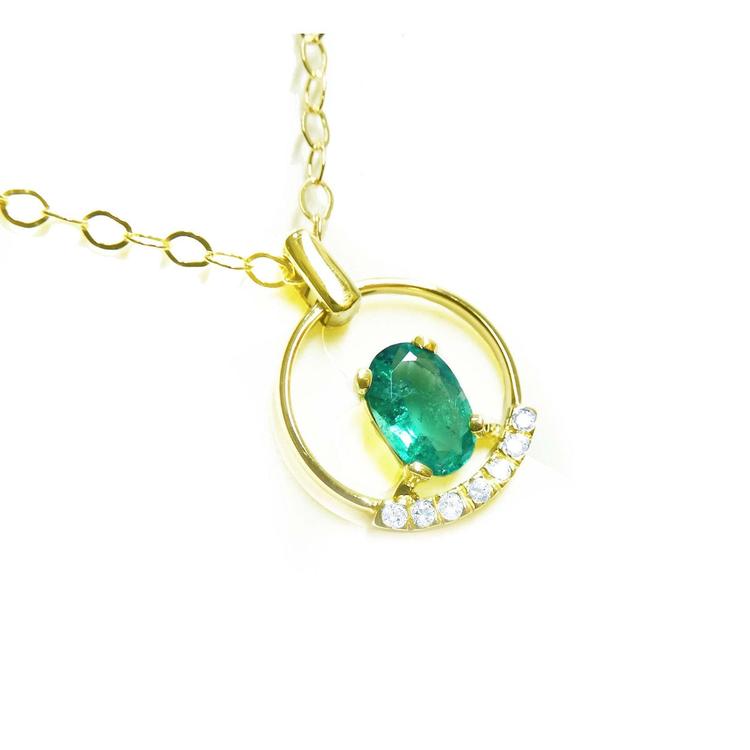 14k yellow gold necklace with a natural oval cut colombian emerald and diamonds.