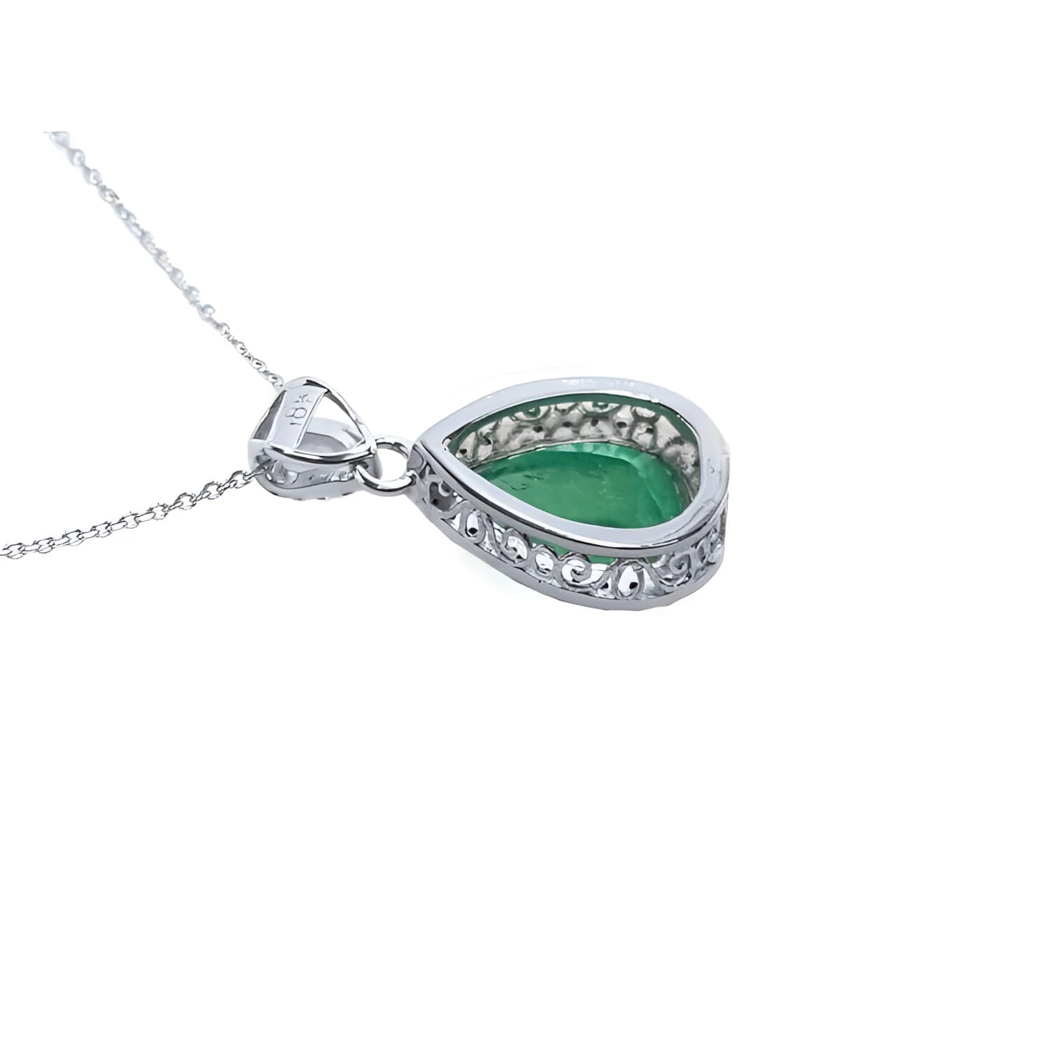 Back view of a pear-cut Colombian emerald pendant in 18K white gold with intricate filigree.
