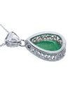 Backside view of a colombian emerald pendant in white gold.