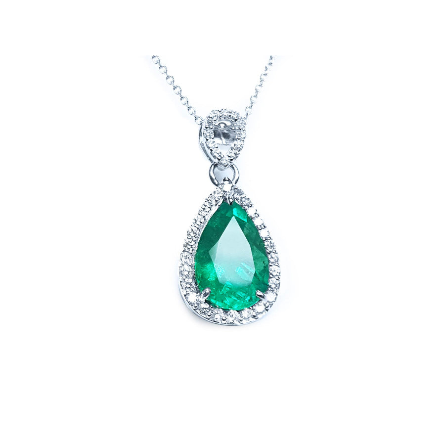 5.83 ct. Colombian emerald pear cut pendant with diamond halo in 18K white gold.