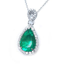 Emerald teardrop pendant with diamond accents on a plain topside visible.