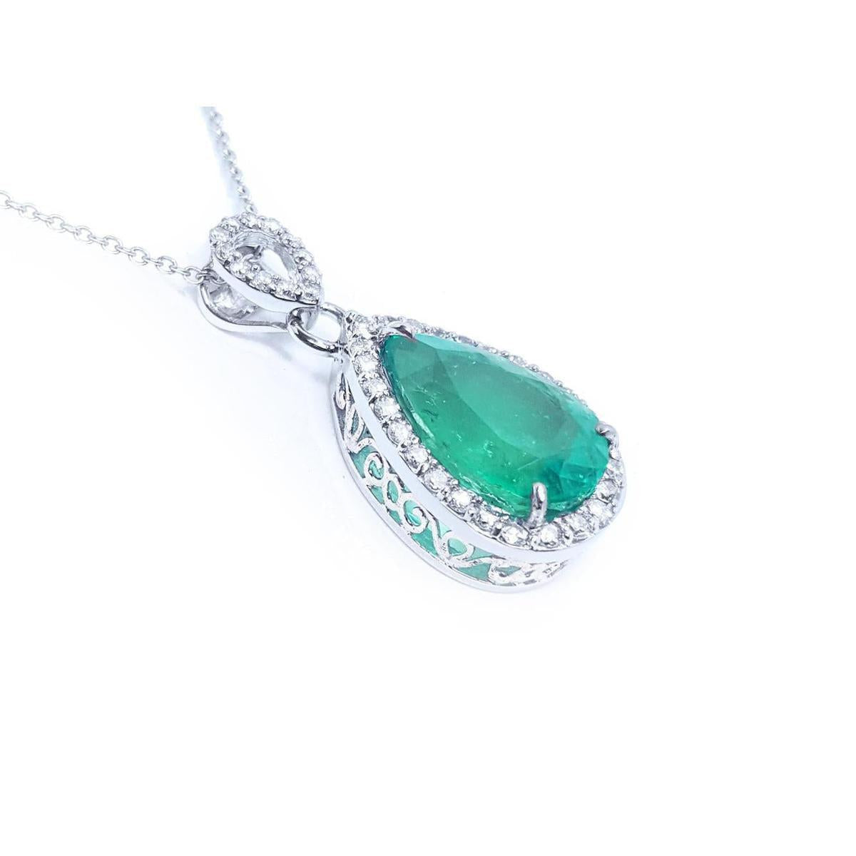 Emerald green teardrop pendant with white gold chain on a right side position topside and gallery visibles.