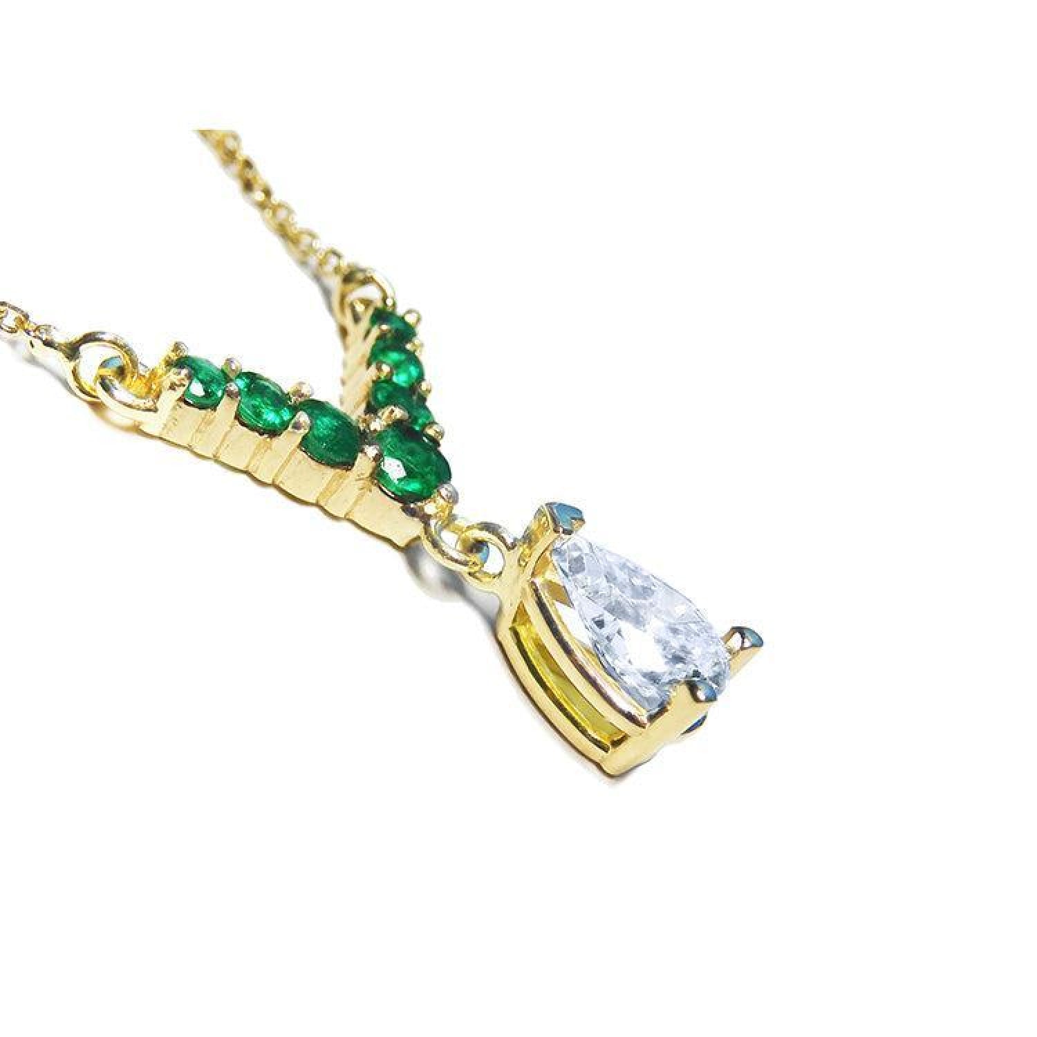 14K gold necklace with a 0.69 ct pear diamond and seven round emeralds in a V-shape.