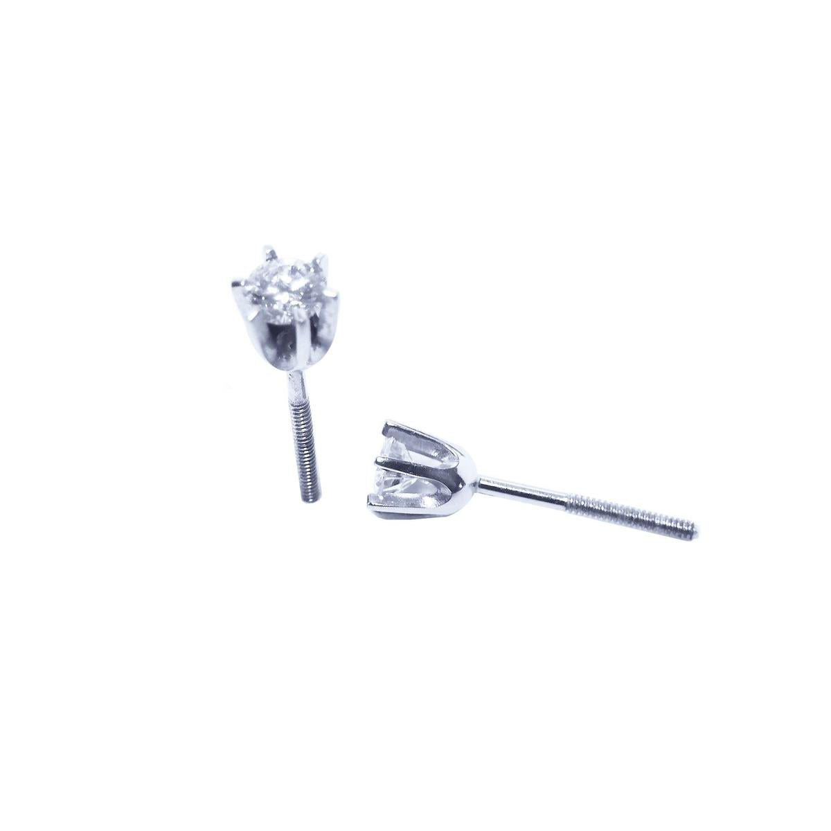 A pair of a 14k white gold diamond stud earrings, underside profile view.
