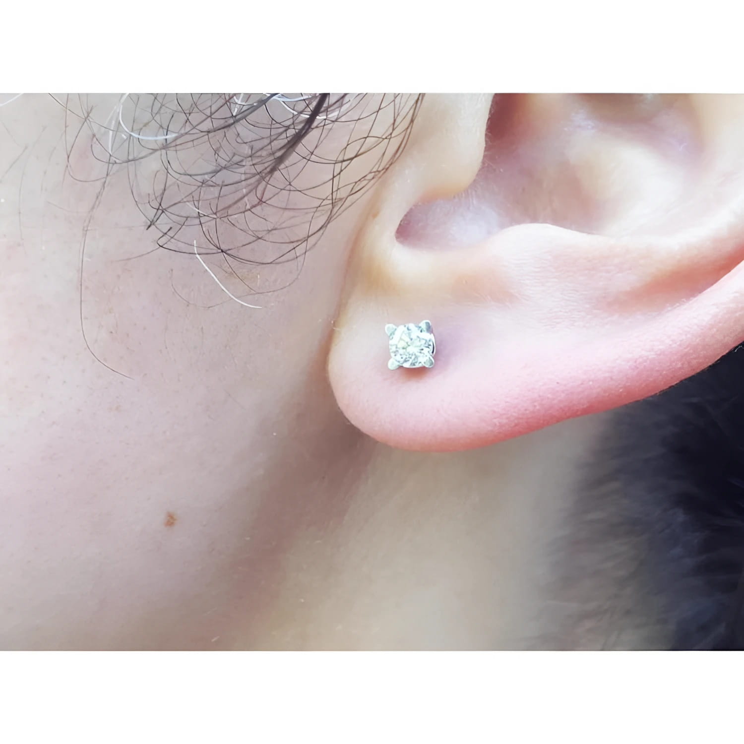 0.46 ct round brilliant natural diamond stud earring with screw back, set in 14K white gold on an ear.