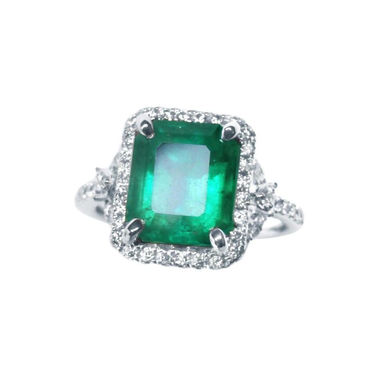 This emerald-cut with a halo diamond emerald ring crafted in white gold, is on a front position full top view.