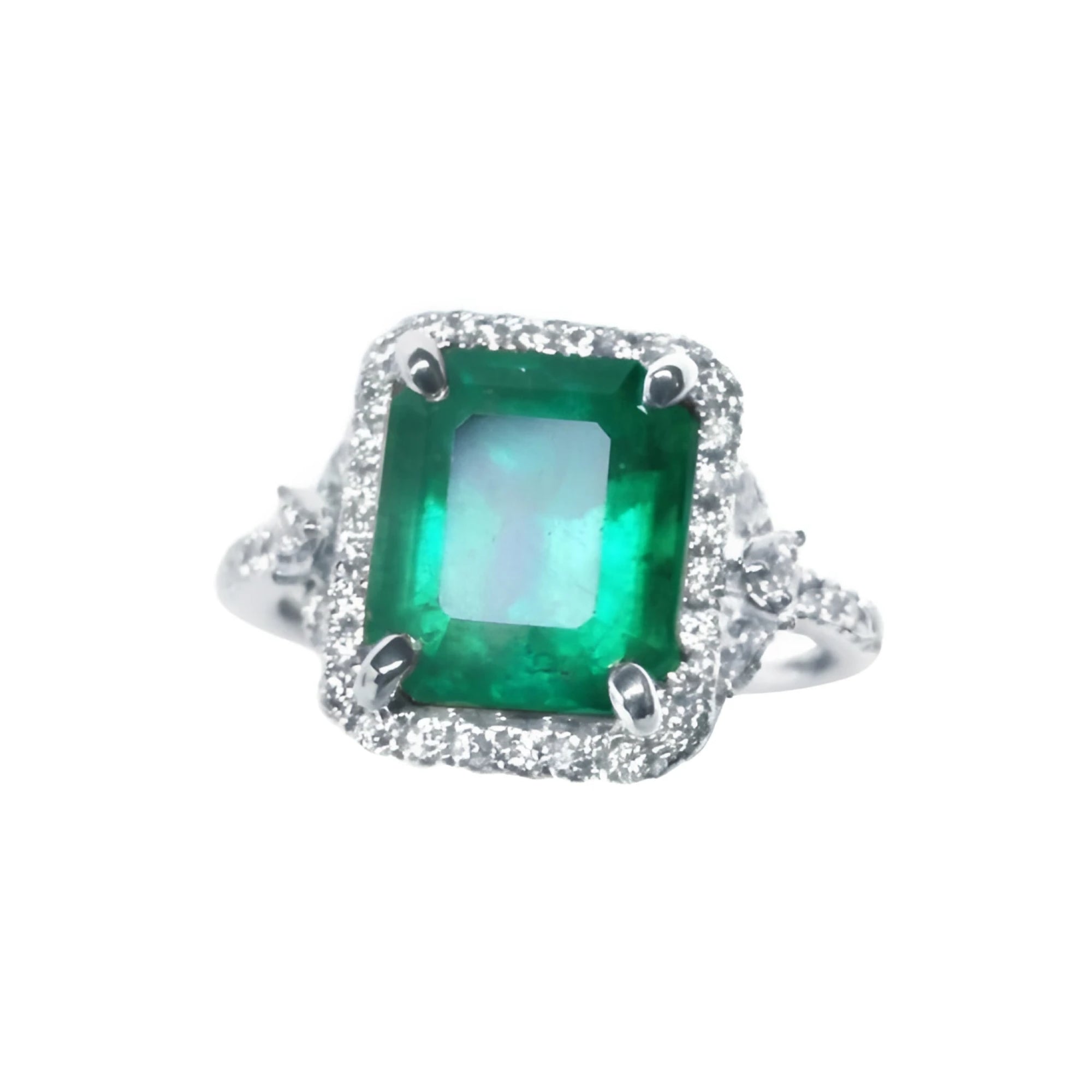 This emerald-cut natural colombian emerald ring for women with a halo diamond is crafted in 14k white gold.