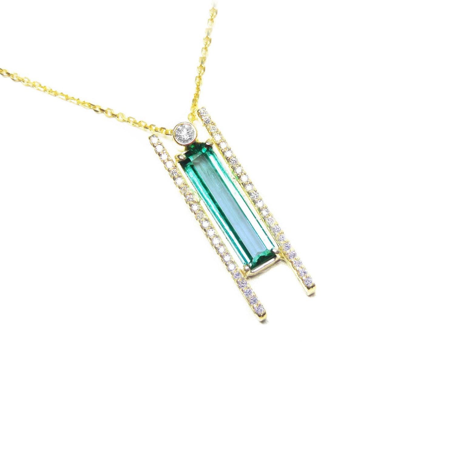 14k yellow gold necklace with a natural colombian emerald gemstone and small lateral diamonds.