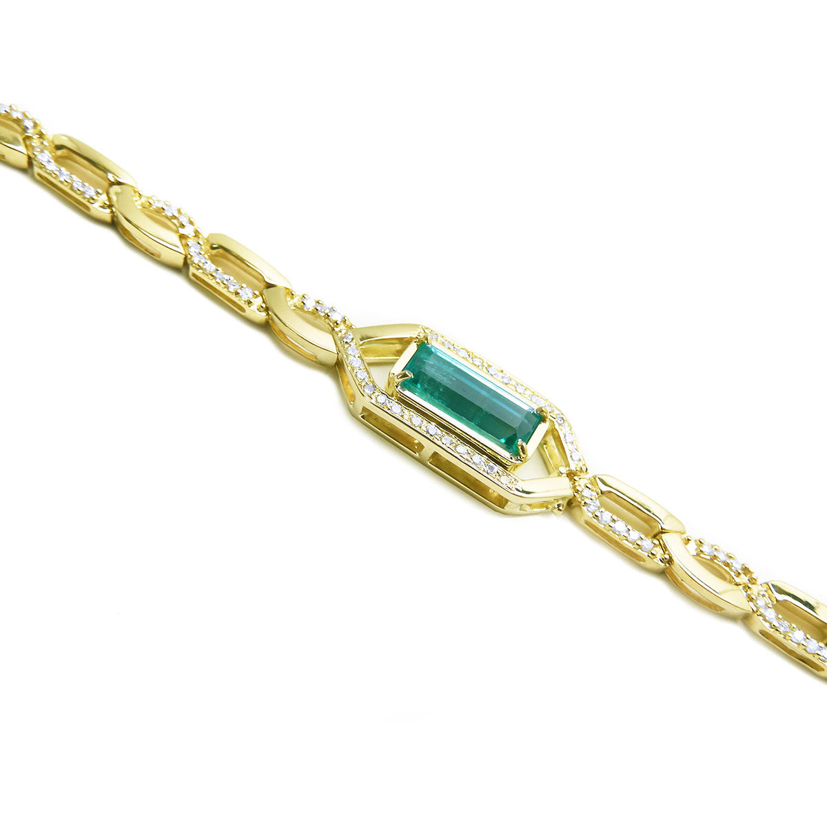 Gold bracelet with a rectangular colombian emerald and accent diamonds on a white background
