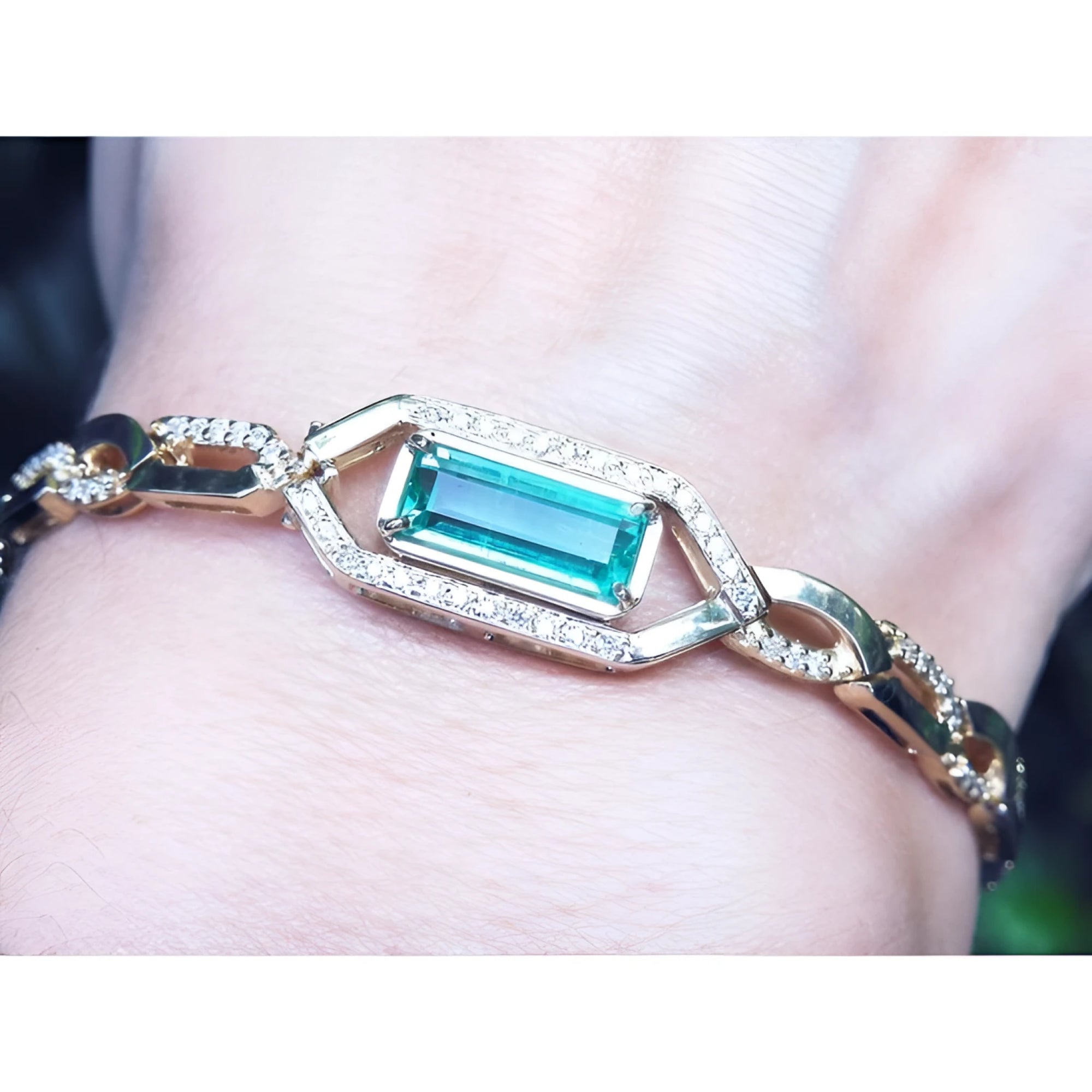 Gold bracelet with a rectangular natural colombian emerald emerald-cut vibrant bluish medium green hue.