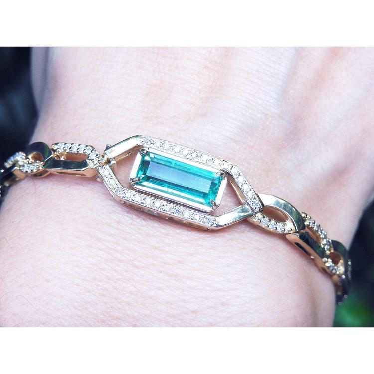 Gold bracelet with a rectangular natural colombian emerald emerald-cut vibrant bluish medium green hue.