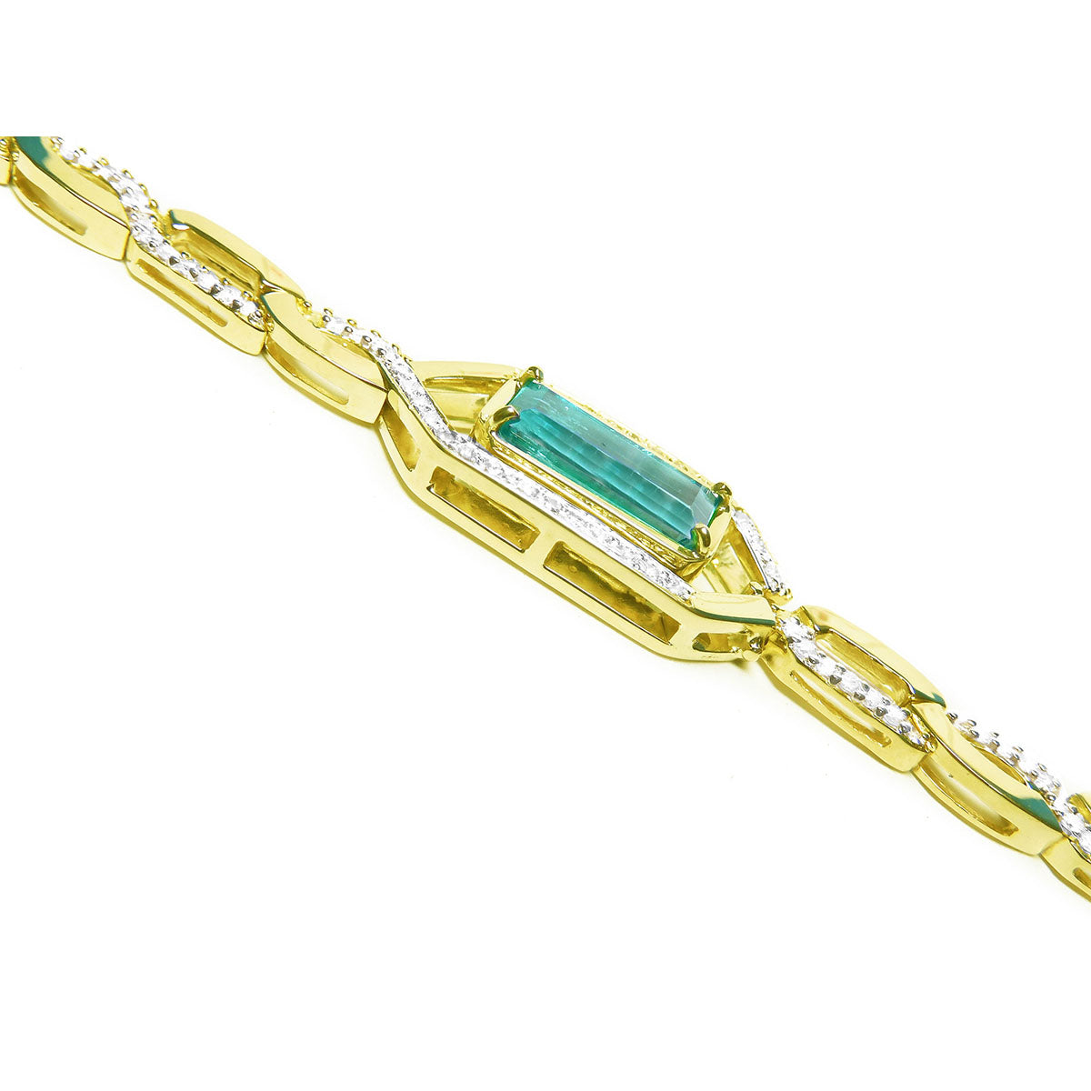 The side profile view of a gold bracelet with emerald and diamond accents on a white background