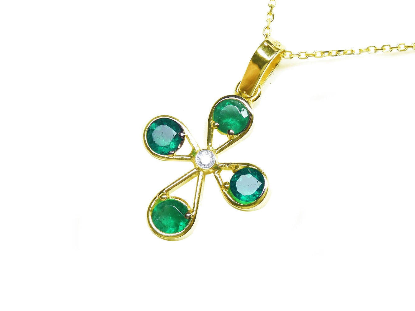 Gold cross emerald pendant necklace four leaves and a center diamond topside view.