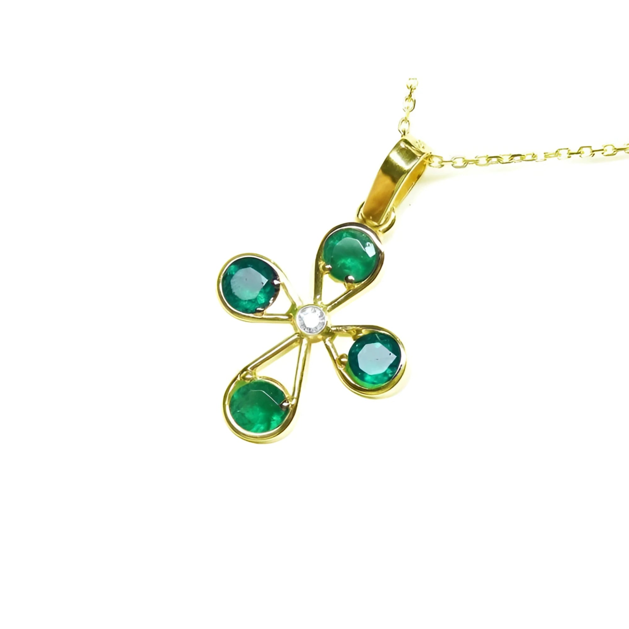 18K yellow gold cross pendant with four round Colombian emeralds and a central diamond.