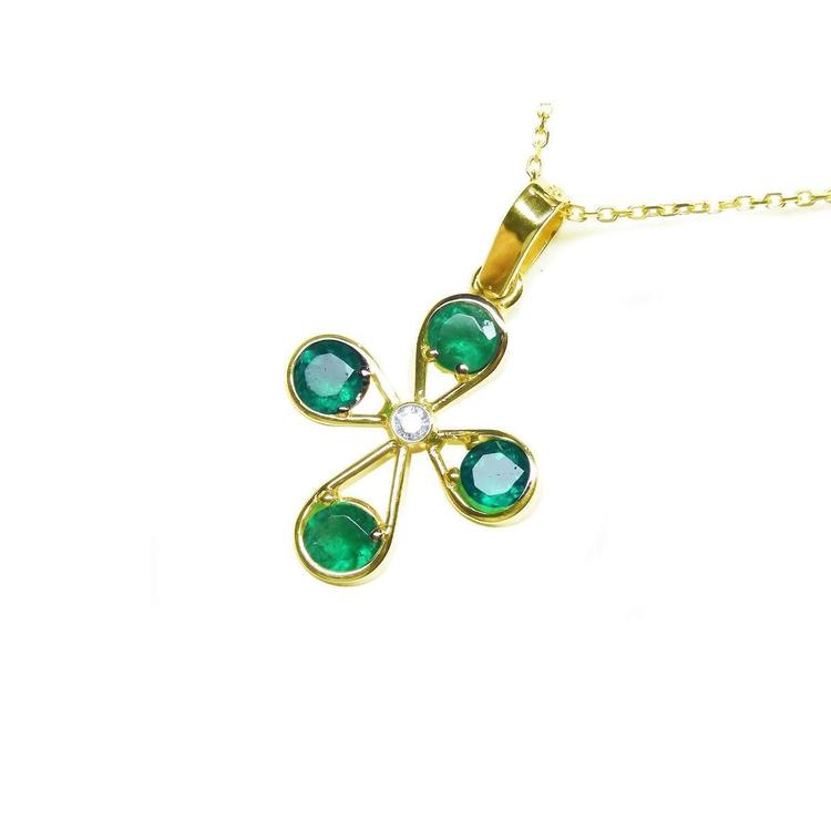  Gold cross emerald pendant necklace four leaves and a center diamond topside view.